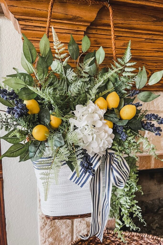 How To Make 27 Unique Summer Front Door wreaths And More-Basket wrapped with yarn, filled with beautiful lemons and fresh greenery. Topped off with a blue and white stripe bow. 