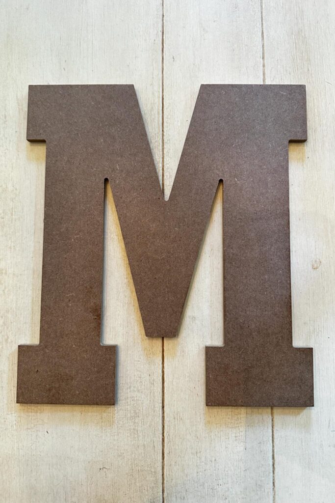 A wooden letter M