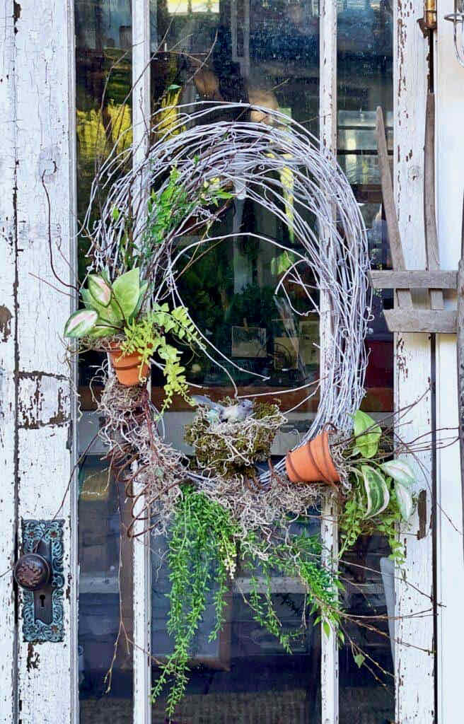 How To Make 27 Unique Summer Front Door wreaths And More-White grapevine wreath with old box springs wired on. Small pots of greenery inserted into the springs with added greenery and a bird's nest in the center box spring. 
