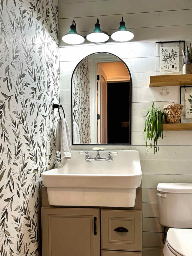 farmhouse bathroom with green and white wallpaper 