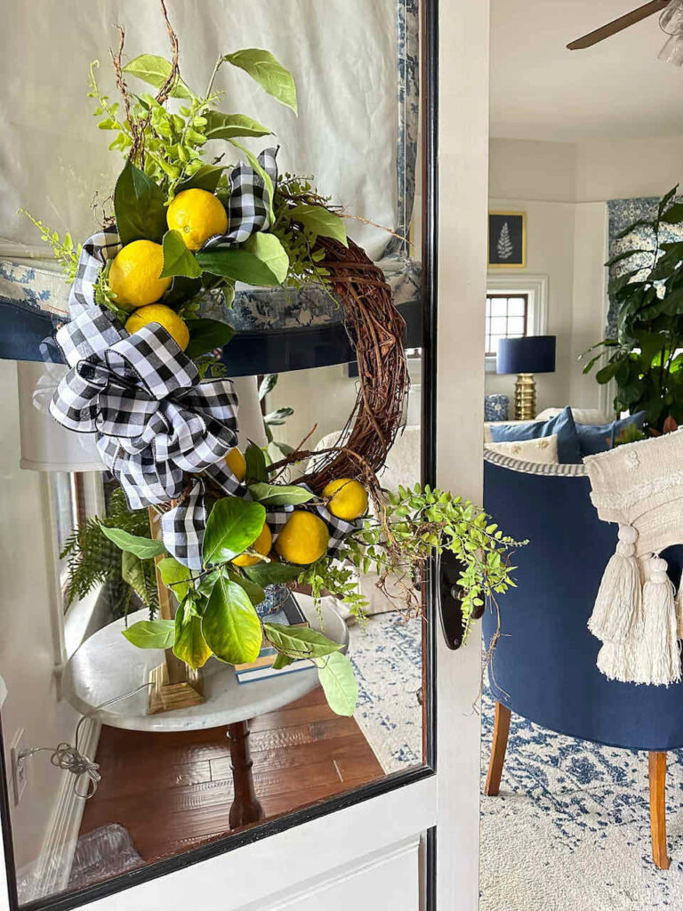 29 things to do with old lemons - add lemons to a wreath and hang it on your front door wreath on door with lemons and a black and white bow