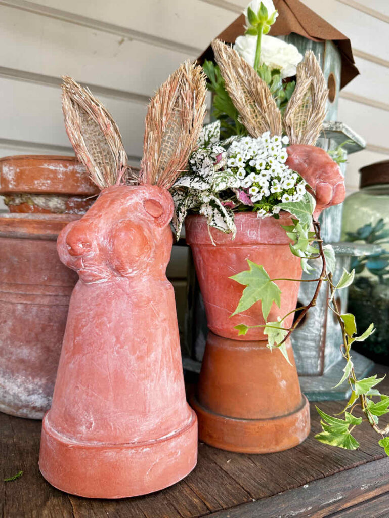 DIY Easter Rabbit Terra Cotta Pots - a flower pot with a rabbit head on top. Clay carrots tied around the neck 