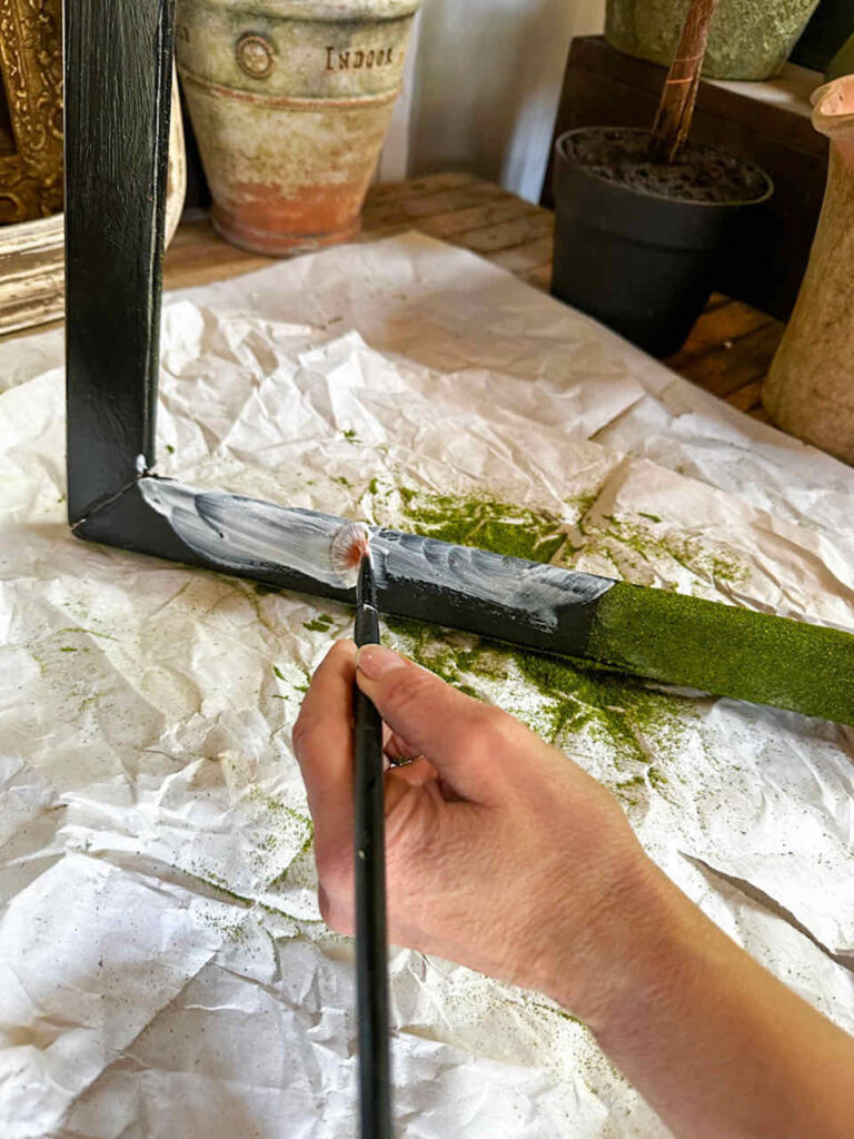 How to Make An Easy DIY Moss Frame Wall Art Gallery-painting mod podge onto a wooden picture frame and then sprinkling it with  powdererd turf
