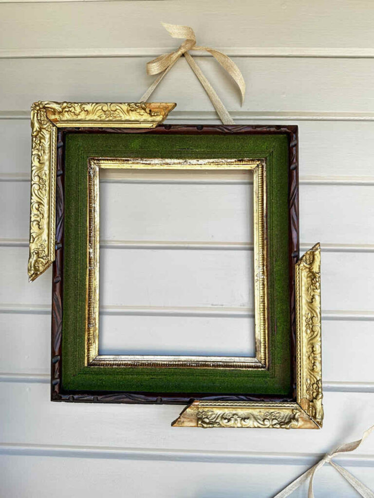 How to Make An Easy DIY Moss Frame Wall Art Gallery-A picture frame with a smaller frame that is broken into two pieces and hot glued to the corners of the larger frame. 