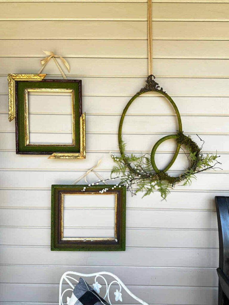 Three moss picture frames hanging on the wall of the porch. 