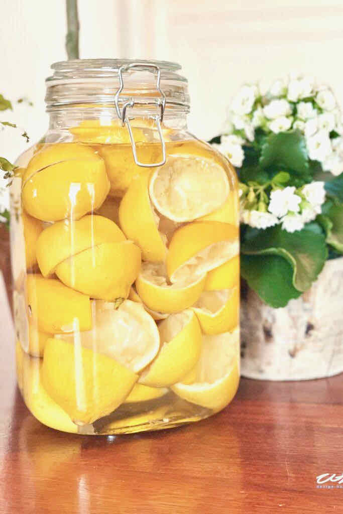 29 things to do with your extra lemons-jar of cut up lemon rinds soaking in vinegar