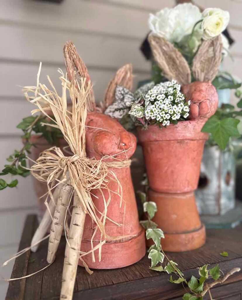 DIY Easter Rabbit Terra Cotta Pots - a flower pot with a rabbit head on top. Clay carrots tied around the neck