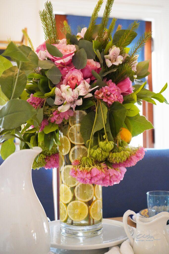 pink flowers in an arrangement with  lemon slices in the vase