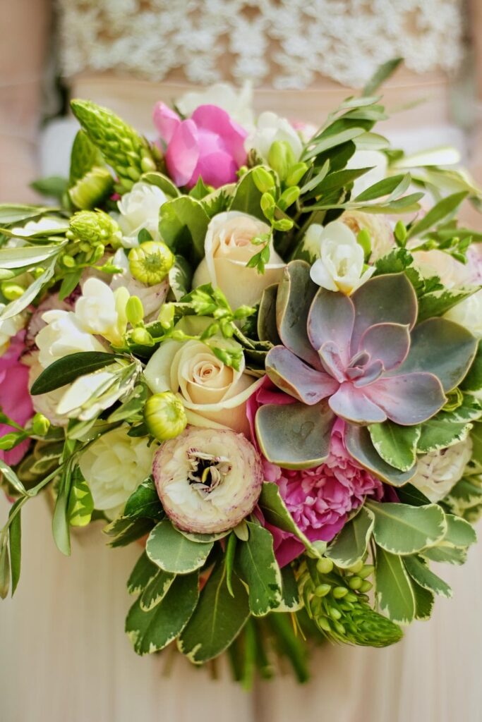 Wedding bouquet created with fresh flowers and succulents.