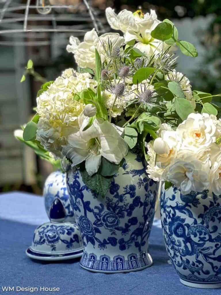 white flowers on the tabke in blue and white chinoiserie pots