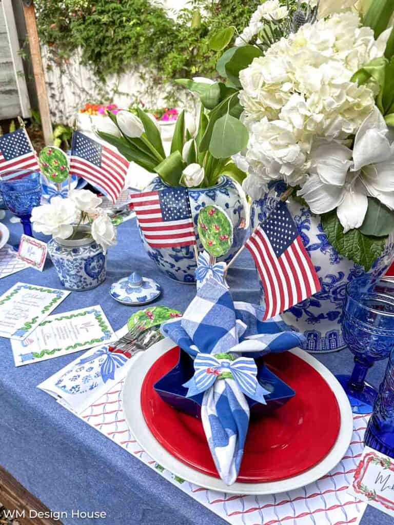 Overhead view of 4th of July summer dinner party with red, white, and blue dishes and free dinner party printables