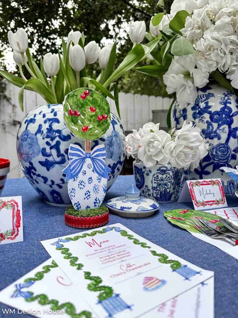 Customized red, white, and blue dinner party menu printable on a 4th of July tablescape