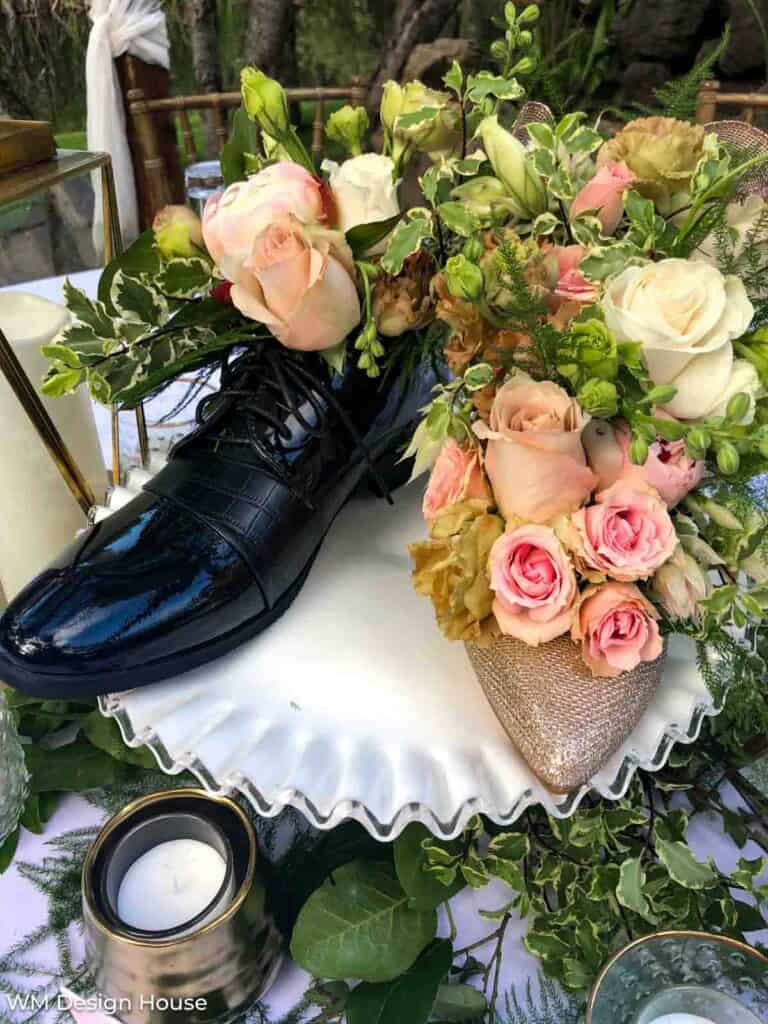 Shoes filled ith flowers for   a coenterpiece at a wedding 