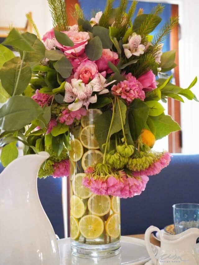 pink flowers in an arrangement with lemon slices in the vase