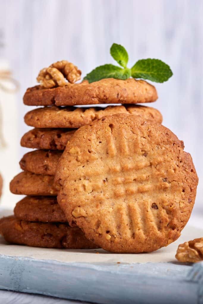 stack of peanut butter cookies with a bottle of milk