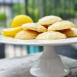 The Best Lemon Ricotta Cookies: Nordstrom Cafe with Glaze- Lemon Ricotta cookies with glaze on a white ceramic pedastool tray