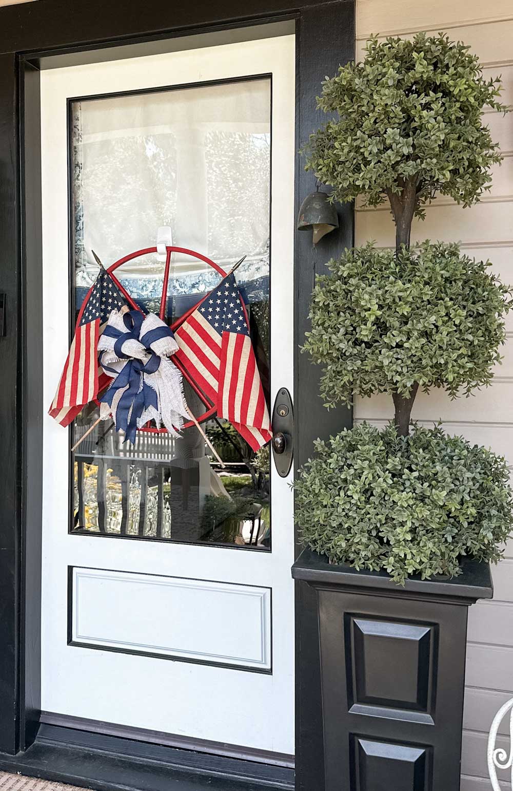 patriotic wagon wheel wreath hanging on the front door 
