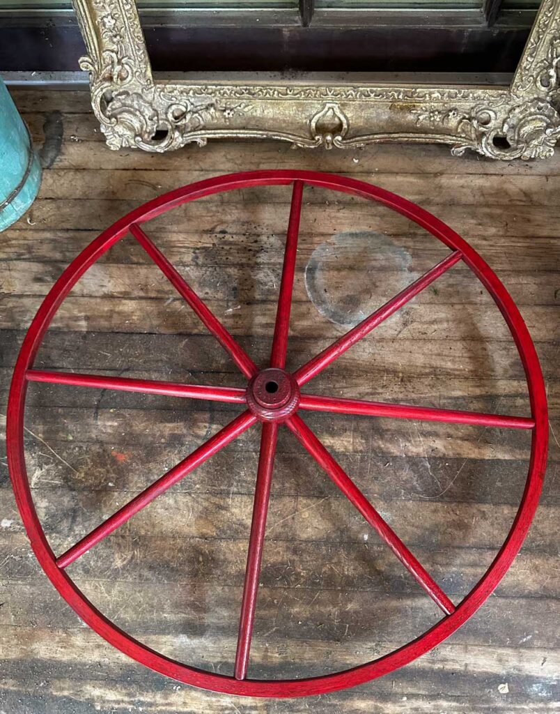 wagon wheel spray painted red for patriotic summer wreath