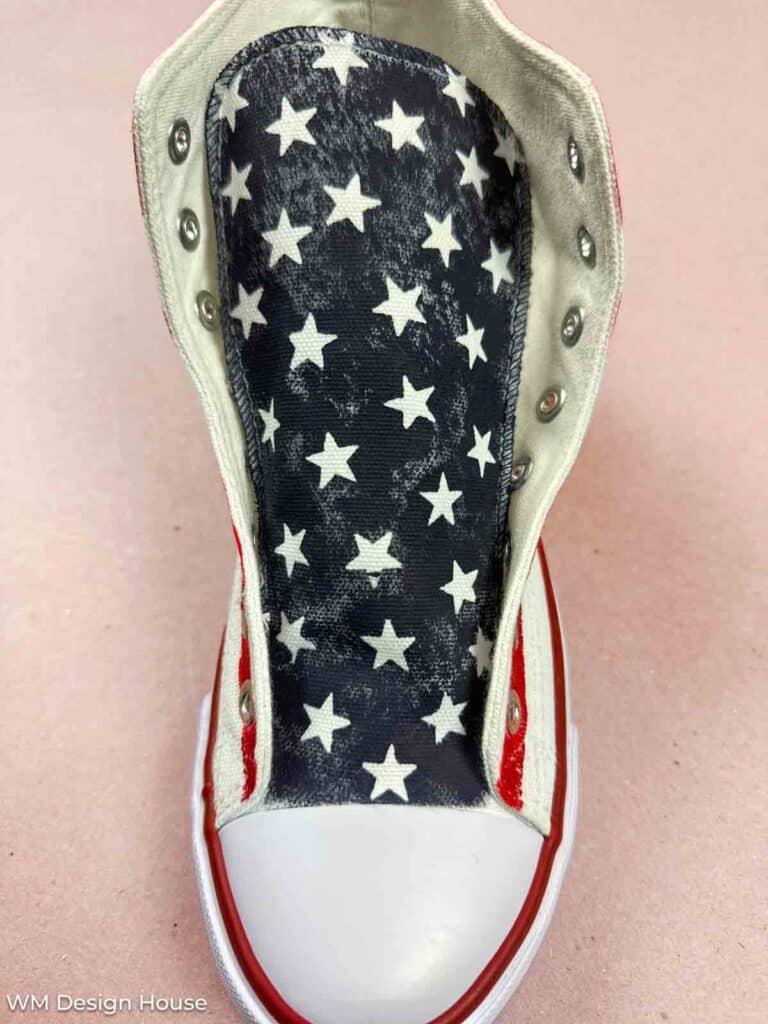 Close up of Patriotic painted shoes. A tongue of the shoe is painted navy blue with white stars. 