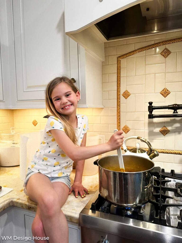 Mrs. Wages Dill Pickle Recipe: How To Make Quick Pickles- little girl stirring a pot on the stove making pickles 