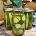 Mrs. Wages Dill Pickle Recipe: How To Make Quick Pickles- Three bottles of pickles sitting on a bread board