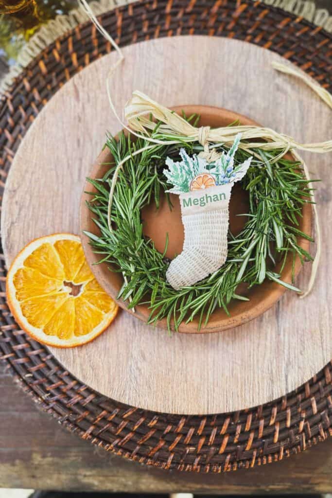 Fresh dried rosemary wreath with a stocking name card as a place card holder for Christmas dinner. 