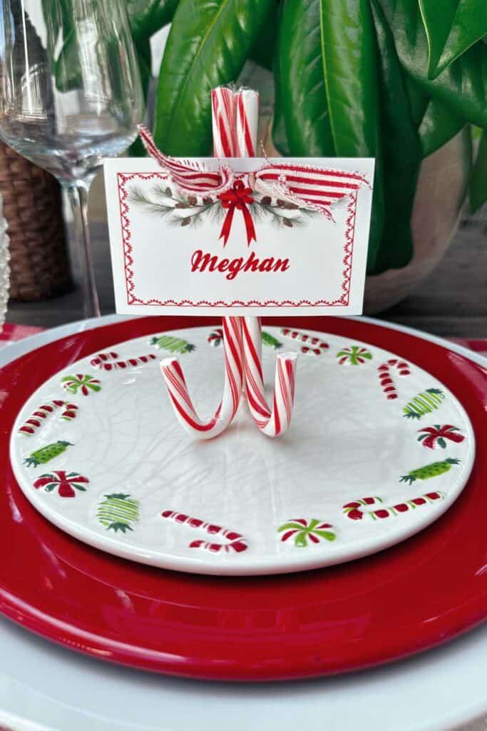 Three red candy canes glued together to create a name card stand.
