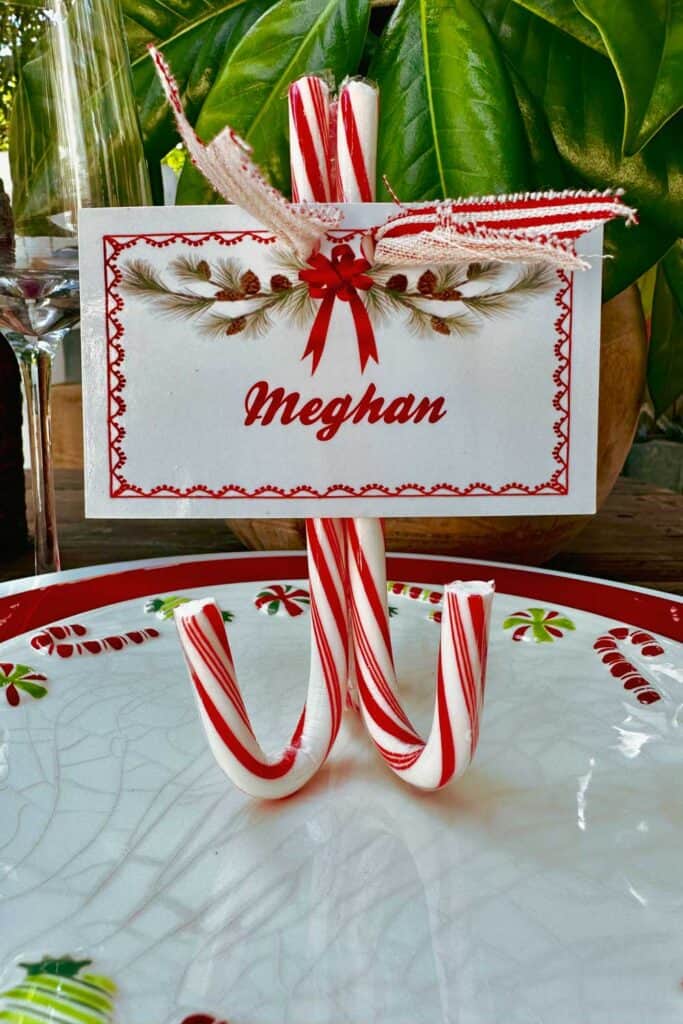 Three red candy canes glued together to create a name card stand. 