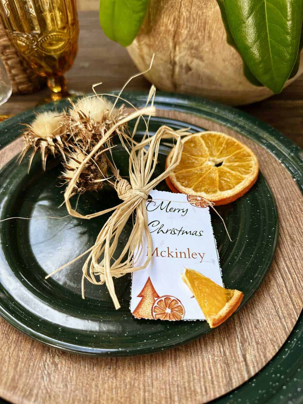 Natural looking name card holder made with thistles and fresh dried oranges 