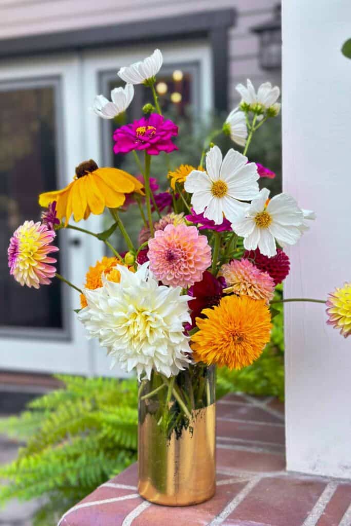 mixed bouquet of flower in a glass vase with gold foil 