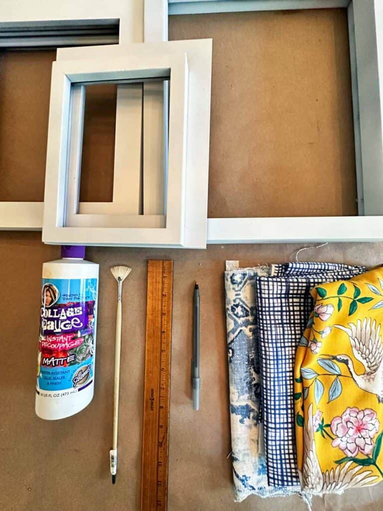 Supplies needed to make fabirc covered picture frames. Ruler, glue, pen, frames and fabric. 