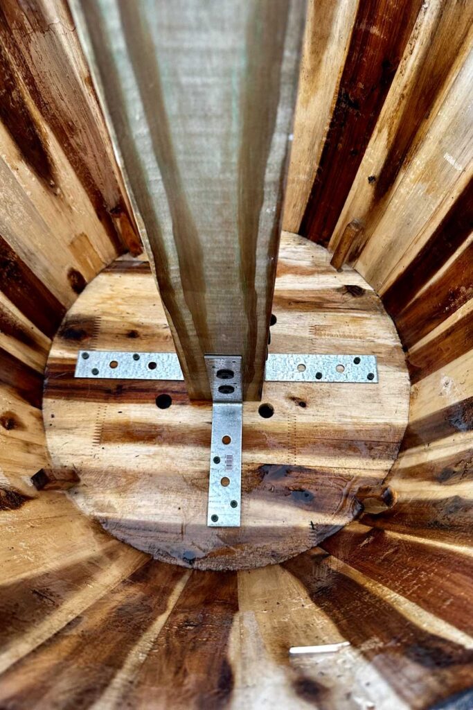 Securing the post inside of the wine barrel with L brackets 