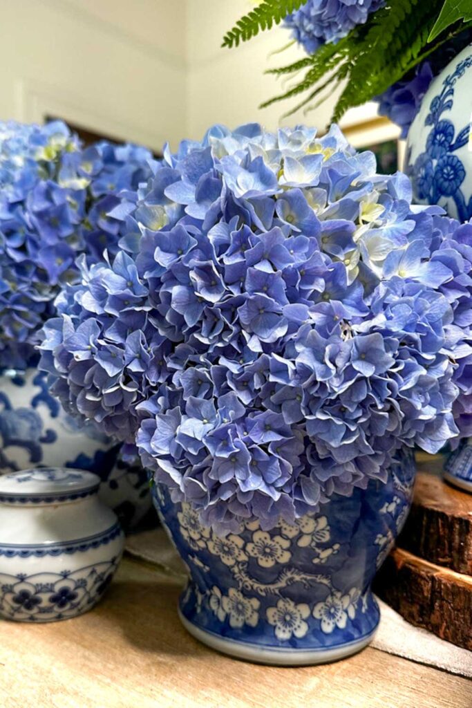 table with several arrangements of blue hydrangeas on the table