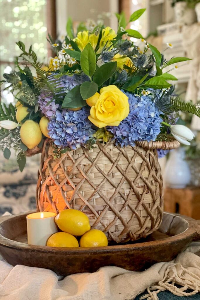 basket full of blue and yellow flowers with lemons 