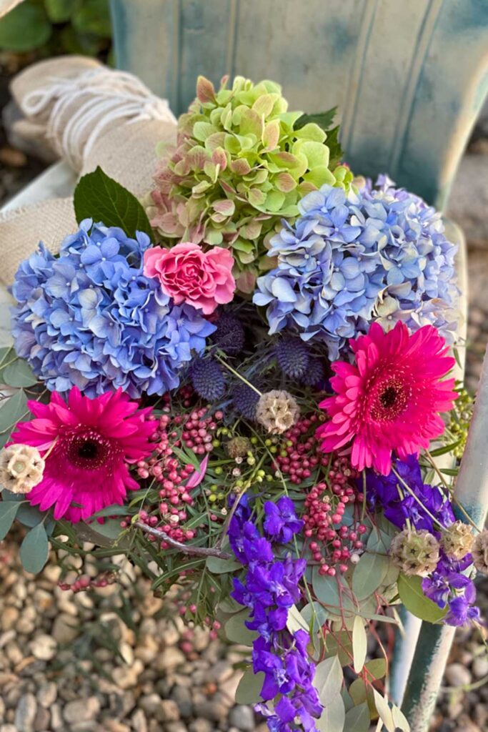 bright color flower bouquet sitting on a chair 