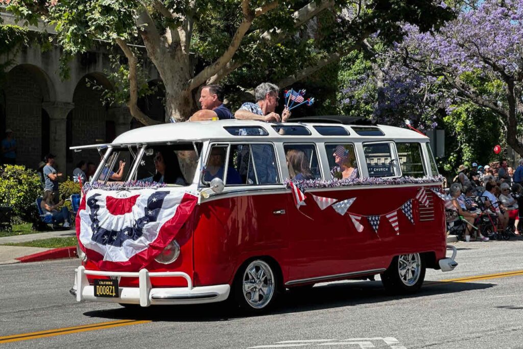 City major in 4th of July parade riding in a vintage vw bus 