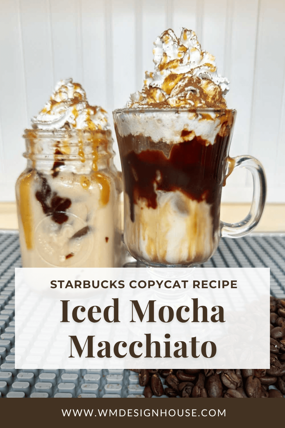 Two iced mocha macchiatos topped with whipped cream and caramel drizzle, one served in a mason jar and the other in a glass mug, sit on a mat with coffee beans nearby. Text overlay advertises an easy Starbucks copycat mocha macchiato recipe.