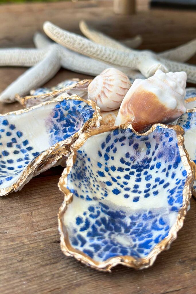 Oyster Shells decoupaged with blue and white napkin with gold foil trim 