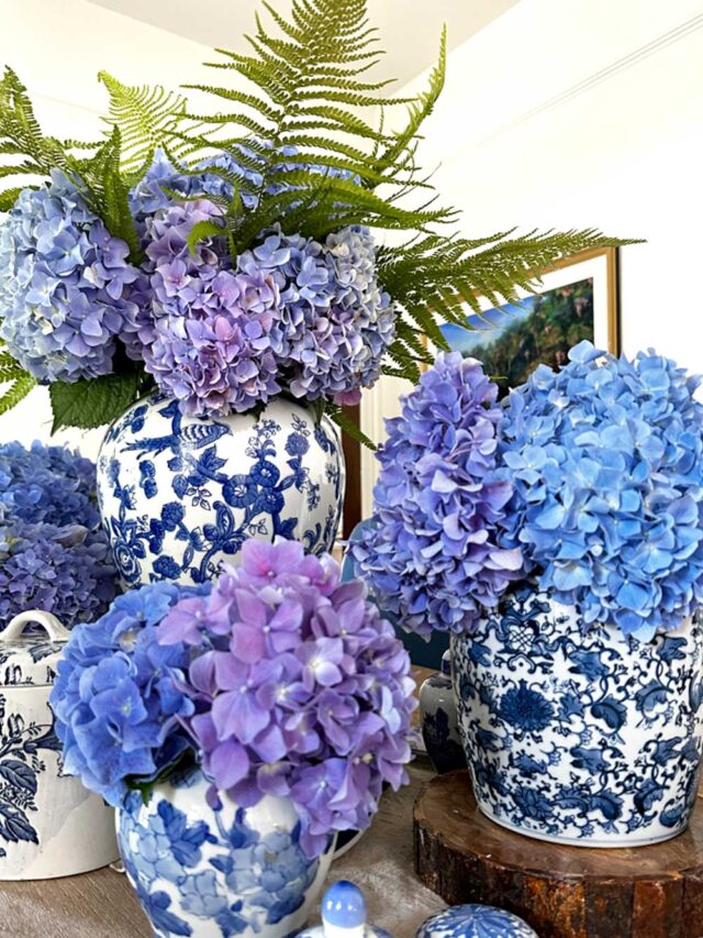 table with several arrangements of blue hydrangeas on the table