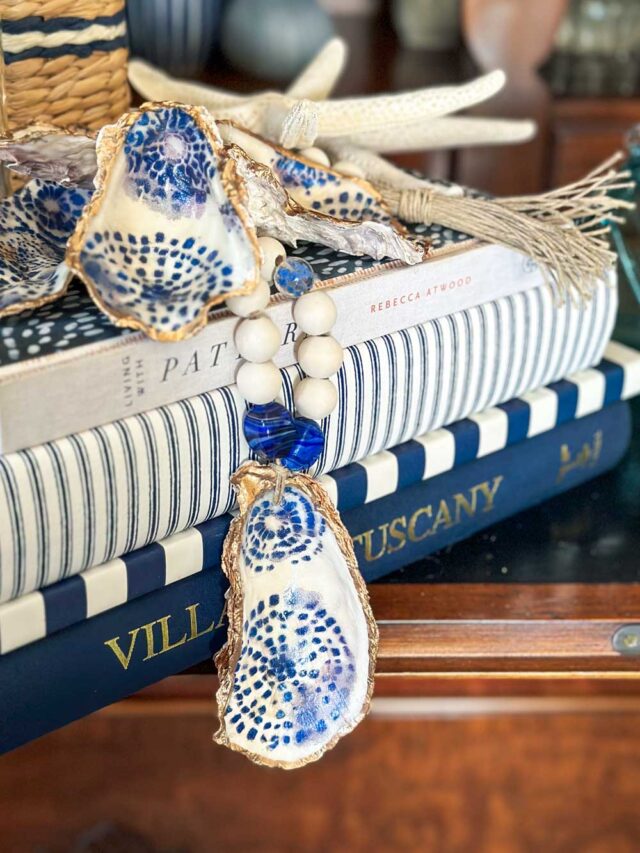 set of books decorated with a wood bead garland and oyster shell