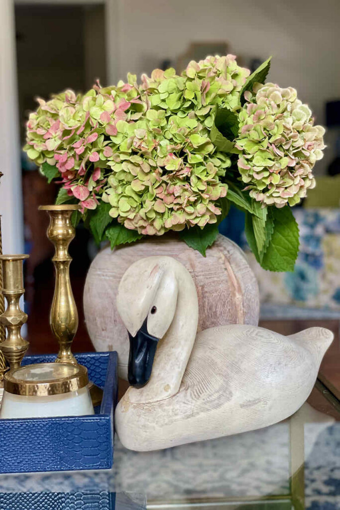 Flower arrangement with green hydrangeas in a wooden vase 