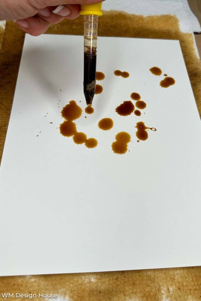 using an eye dropper to dye paper with coffee