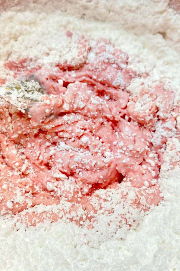 Mixing cream cheese, butter and vanilla and adding the powdered sugar