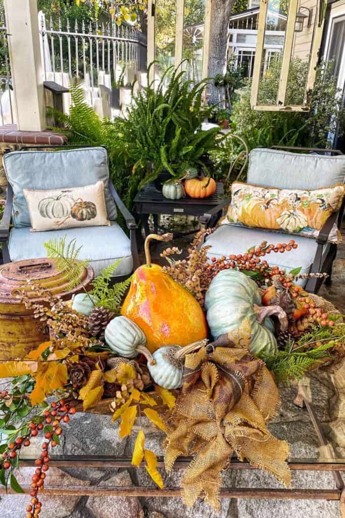21 Cozy Ways to Decorate Your Outdoor Spaces For Fall
- back porch decorated for fall 