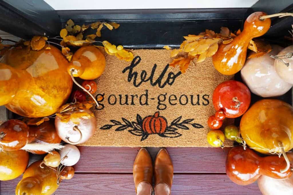 front door mat that says hello gourdeous with lots of gourds