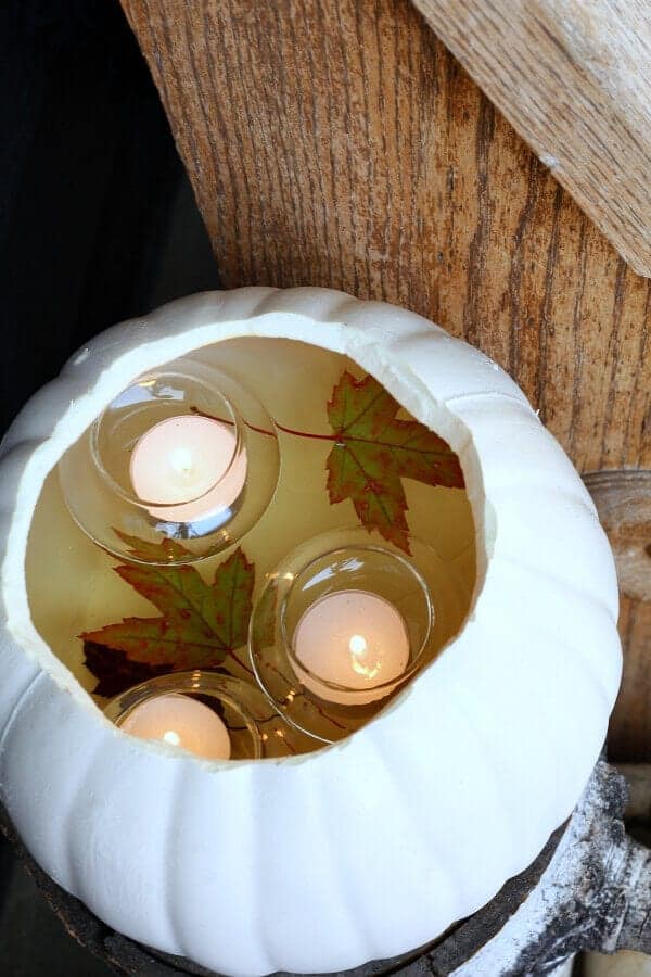 Floating candles in a pumpkin for fall decor. 