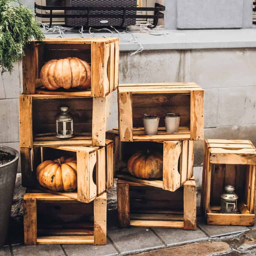 Decorate your fall front porch with a rustic and cozy atmosphere with wooden crates.