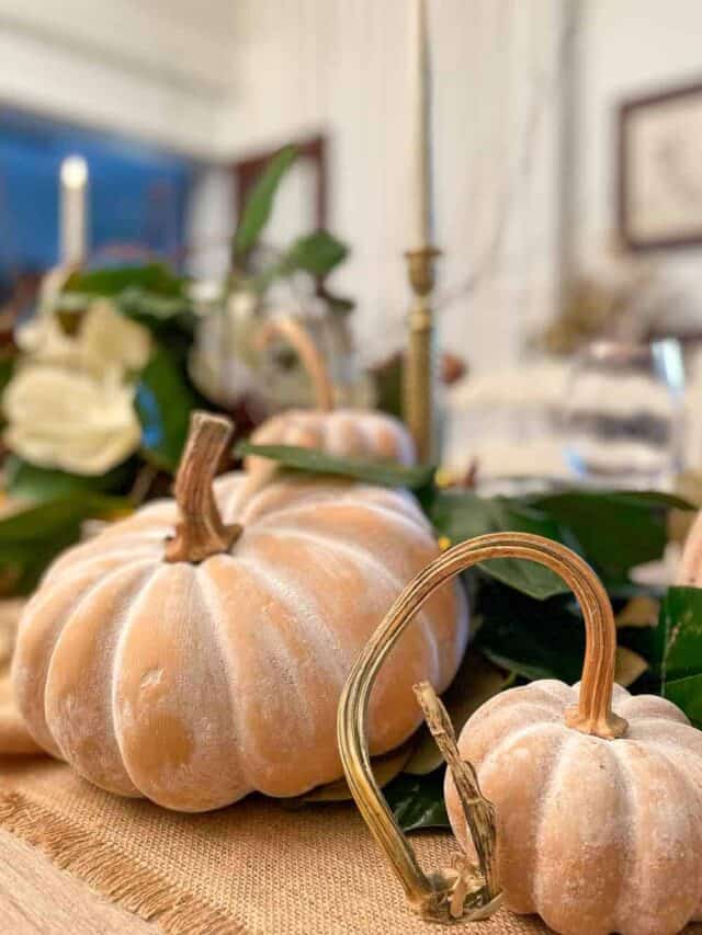 Terra cotta pumpkins on a ceramic cake plate
