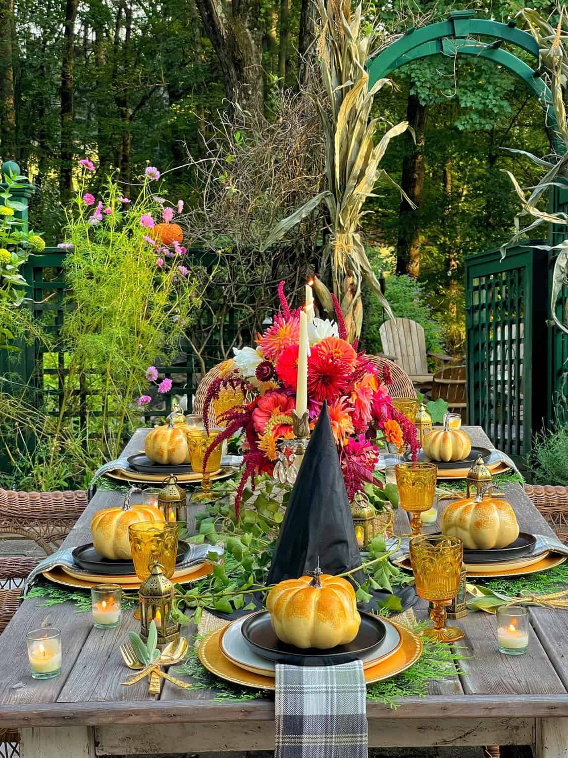 Outdoor garden Halloween Tablescape with pumpkin and witch hats from Bricks 'n Blooms