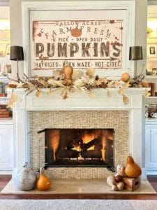 Fall leaf garland made with coffee paper on the mantel above tehefireplace.